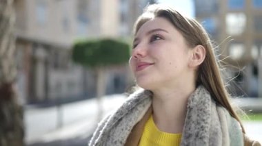 Sokakta kendine güvenen genç sarışın kadın gülümsüyor