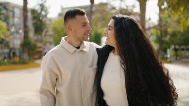 Young couple smiling confident hugging each other standing at park