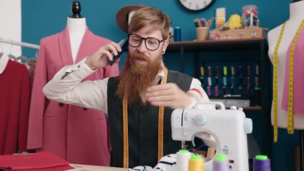 Junger Rotschopf Schneidert Bekleidungsfabrik Mit Unglücklichem Gesichtsausdruck Auf Smartphone — Stockvideo