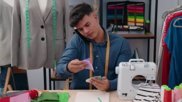 在服装厂 他的小裁缝拿着桌布用智能手机说话 — 图库视频影像