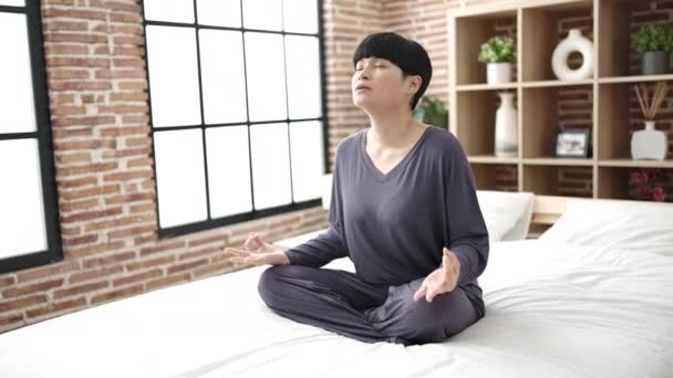 Young Chinese Woman Doing Yoga Exercise Sitting Bed Bedroom — Stock video