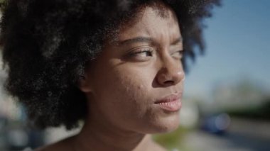 African american woman smiling confident looking to the sky at park