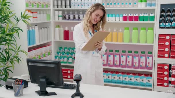 Young Blonde Woman Pharmacist Writing Document Pharmacy — Video Stock