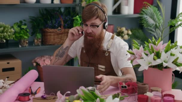 Young Redhead Man Florist Using Headset Laptop Working Flower Shop — Stockvideo