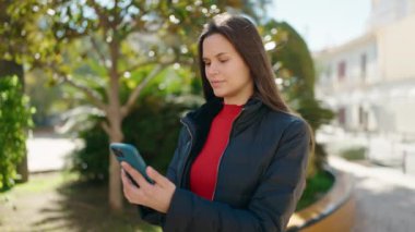 Young woman smiling confident making selfie by the smartphone at park