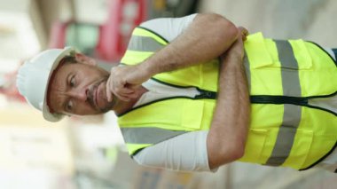 Middle age man architect standing with doubt expression at street