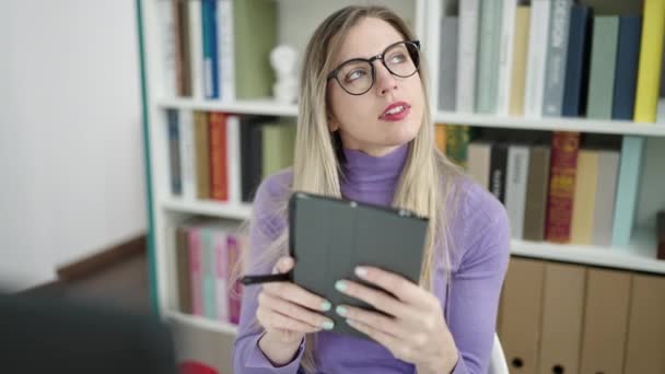 Young Blonde Woman Student Using Touchpad Studying Library University — Vídeo de Stock