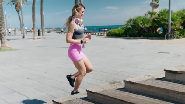 Young Blonde Woman Wearing Sportswear Running Seaside — Stockvideo