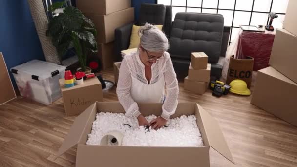 Middle Age Grey Haired Woman Smiling Confident Unboxing Package New — ストック動画