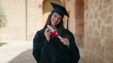 Two women mother and graduated daughter hugging each other at campus university