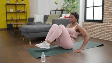 African american woman training abs exercise at home