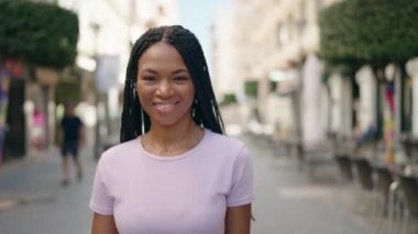 African american woman smiling confident walking at street