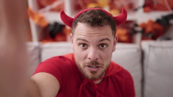 Young Caucasian Man Wearing Devil Costume Taking Selfie Picture Home — Video
