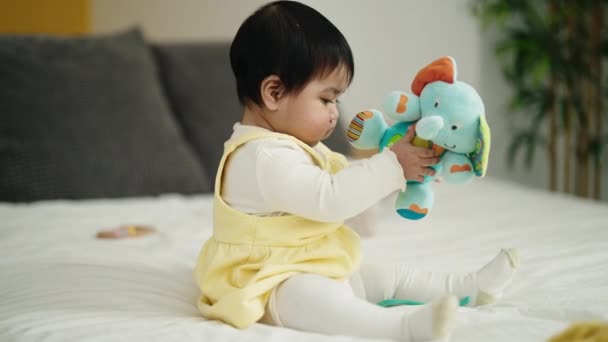 Adorable Hispanic Baby Playing Elephant Doll Sitting Bed Bedroom — Stok video