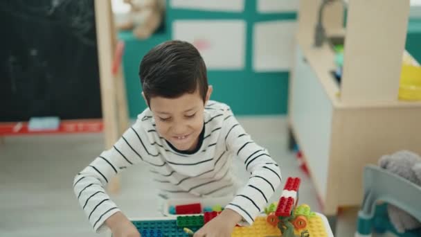Liebenswerter Hispanischer Junge Spielt Mit Dino Spielzeug Tisch Kindergarten — Stockvideo