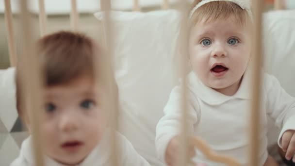 Två Bedårande Barn Håller Leksak Sitter Vaggan Sovrummet — Stockvideo