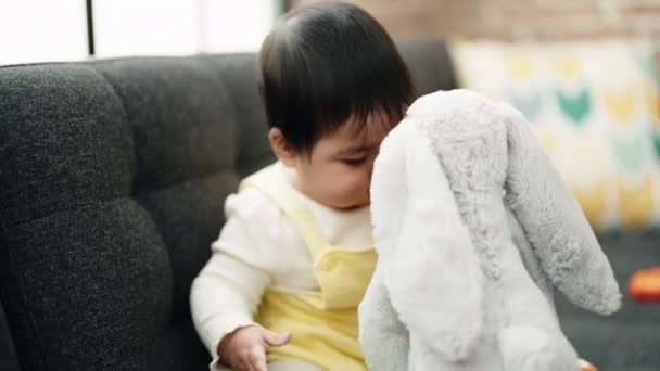 Adorable Hispanic Baby Holding Toy Sitting Sofa Home — Stok video