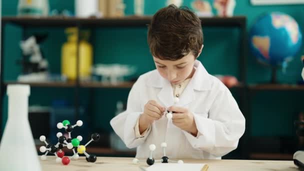 Adorable Hispanic Boy Student Holding Molecules Toy Laboratory Classroom — Vídeo de Stock