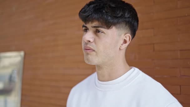 Joven Hombre Hispano Mirando Lado Con Expresión Seria Calle — Vídeo de stock