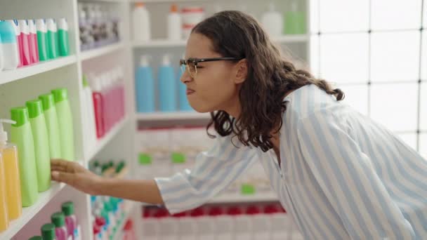 Young African American Woman Customer Holding Gel Bottle Shelving Pharmacy — Stock Video