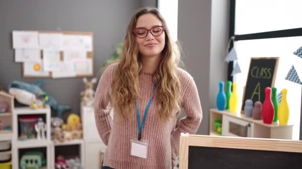 Young Beautiful Hispanic Woman Preschool Teacher Smiling Confident Standing Kindergarten — Wideo stockowe