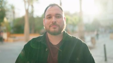 Young plus size man smiling confident standing with arms crossed gesture at street
