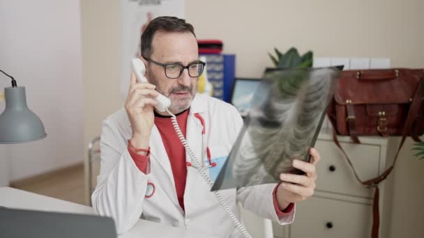 Middle Age Man Doctor Talking Telephone Looking Xray Clinic — Vídeo de Stock