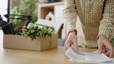 Middle age man business worker dismissed putting document on cardboard box at office