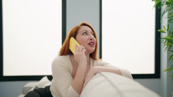 Young Redhead Woman Talking Smartphone Sitting Sofa Home — Stockvideo