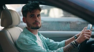 Young hispanic man smiling confident driving car at street