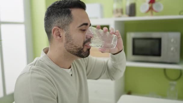 Young Hispanic Man Drinking Water Sitting Table Home — Stockvideo