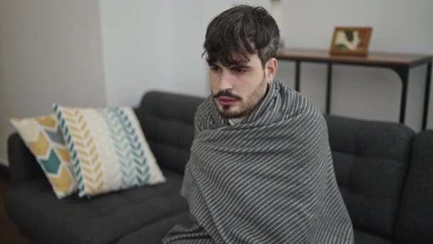 若いですヒスパニック男感じ寒いですカバーで毛布で家 — ストック動画