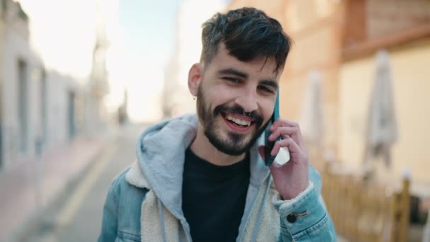 Joven Hombre Hispano Sonriendo Confiado Hablando Teléfono Inteligente Calle — Vídeo de stock
