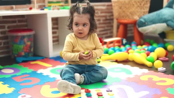 Adorable Hispanic Girl Playing Maths Puzzle Game Sitting Floor Kindergarten — Vídeo de stock
