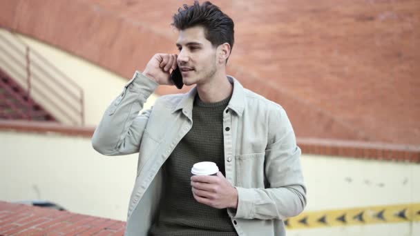 Young Hispanic Man Talking Smartphone Drinking Coffee Street — Stock video