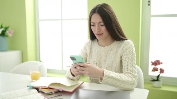 Young Beautiful Hispanic Woman Student Using Smartphone Studying Home — Stockvideo
