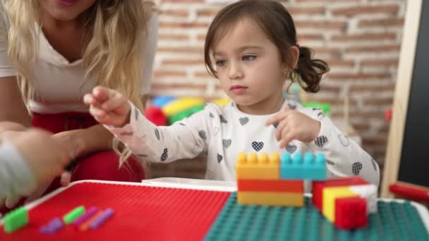 Teacher Boy Girl Playing Construction Blocks Sitting Table Kindergarten — Stok Video