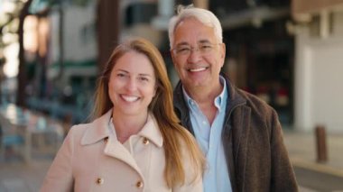 Middle age couple couple smiling confident standing together at street