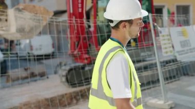 Young hispanic man architect smiling confident standing with arms crossed gesture at street