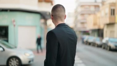 Young hispanic man executive smiling confident standing with arms crossed gesture at street