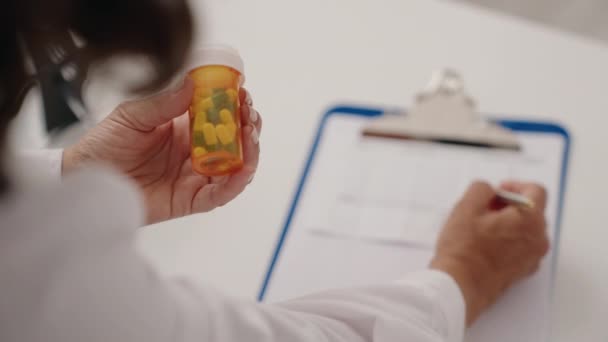 Mulher Meia Idade Farmacêutico Segurando Pílulas Garrafa Escrita Documento Farmácia — Vídeo de Stock