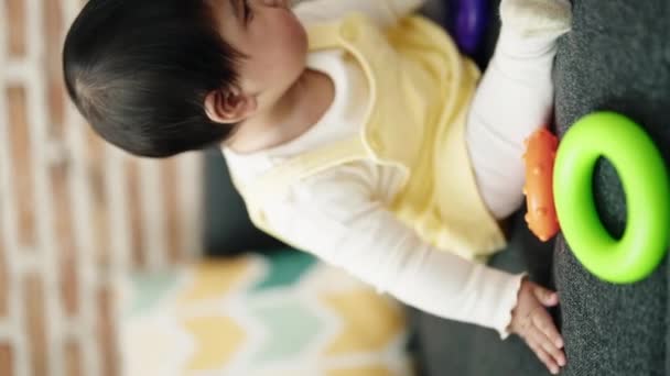 Adorable Hispanic Baby Playing Hoops Sitting Sofa Home — Video