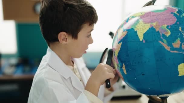 Adorable Hispanic Boy Student Looking Earth Using Magnifying Glass Laboratory — Wideo stockowe