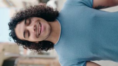 Young latin man smiling confident having video call at street