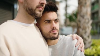 Young couple smiling confident hugging each other at street