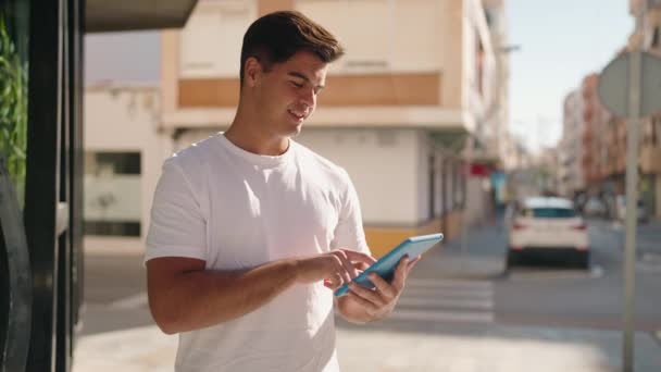 Young Hispanic Man Smiling Confident Using Touchpad Street — Stockvideo