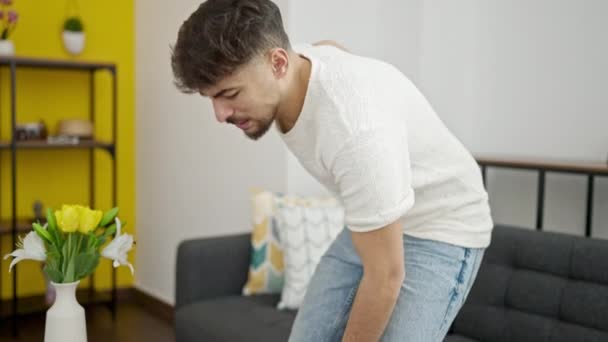 Young Arab Man Suffering Backache Sitting Sofa Home — Stockvideo