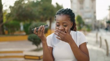 African american woman smiling confident listening audio message by the smartphone at park