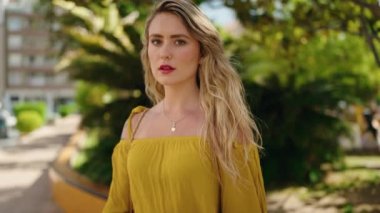 Young woman with relaxed expression standing at park