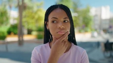 African american woman standing with doubt expression at street